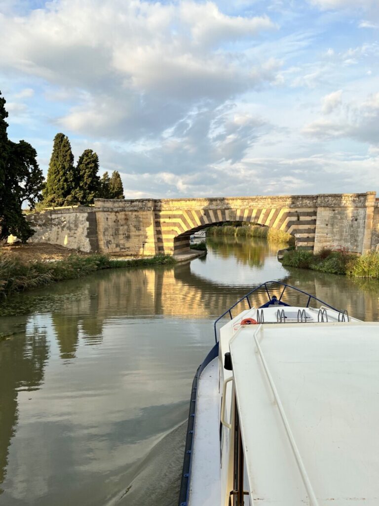 Boat under bridge on the canal du midi